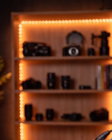 The empty studio I kept: shelves with orange light, nobody in it
